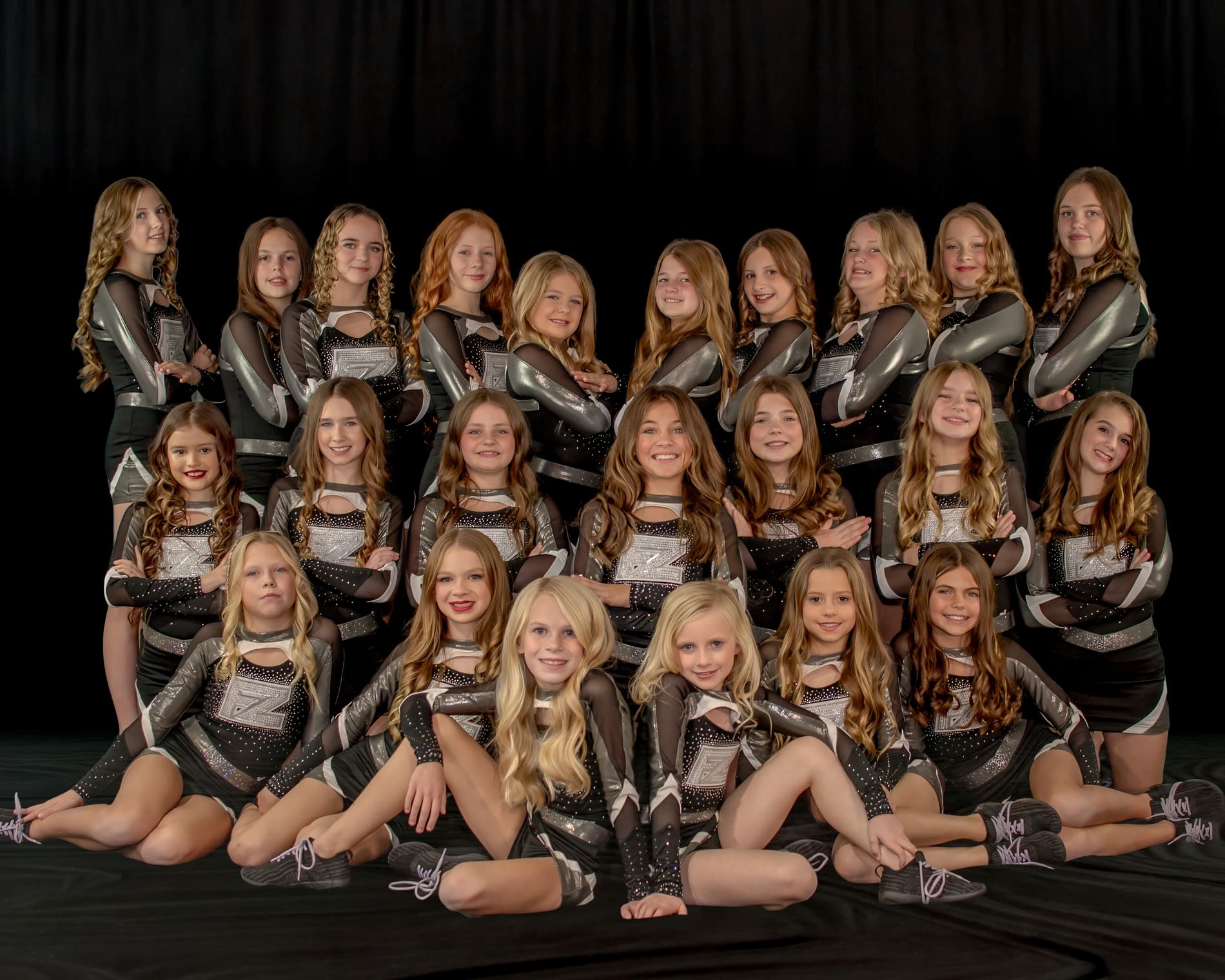 The Flip Zone All Star cheer team in black and silver uniforms